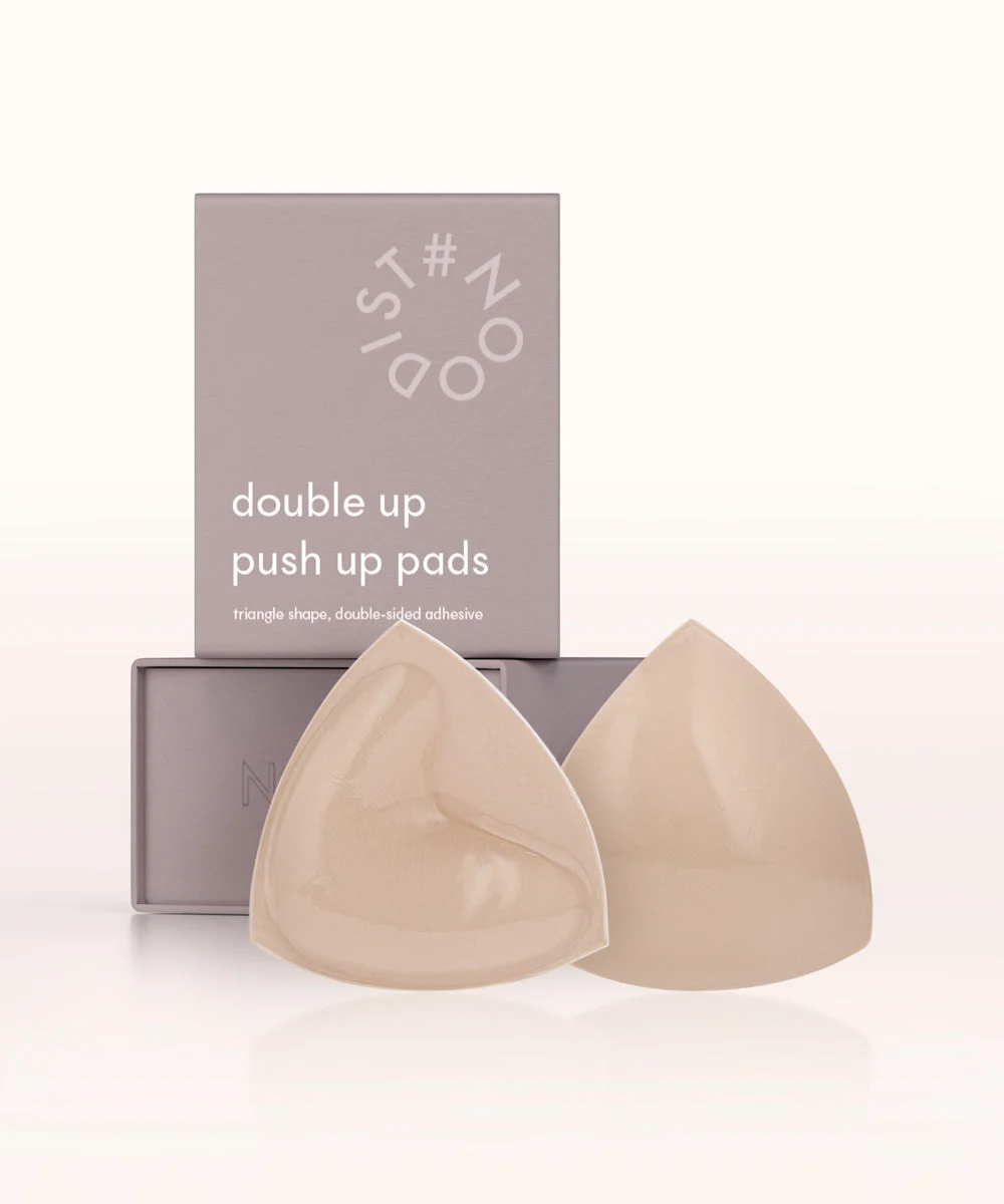 Official NOOD Double Up Triangle Push Up Pads product photograph showing two triangular pads and their packaging.