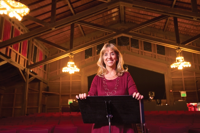 Elizabeth McKoy at a music stand inside the Julia Morgan Theater, photo by Clayton J. Mitchell for Alameda Magazine