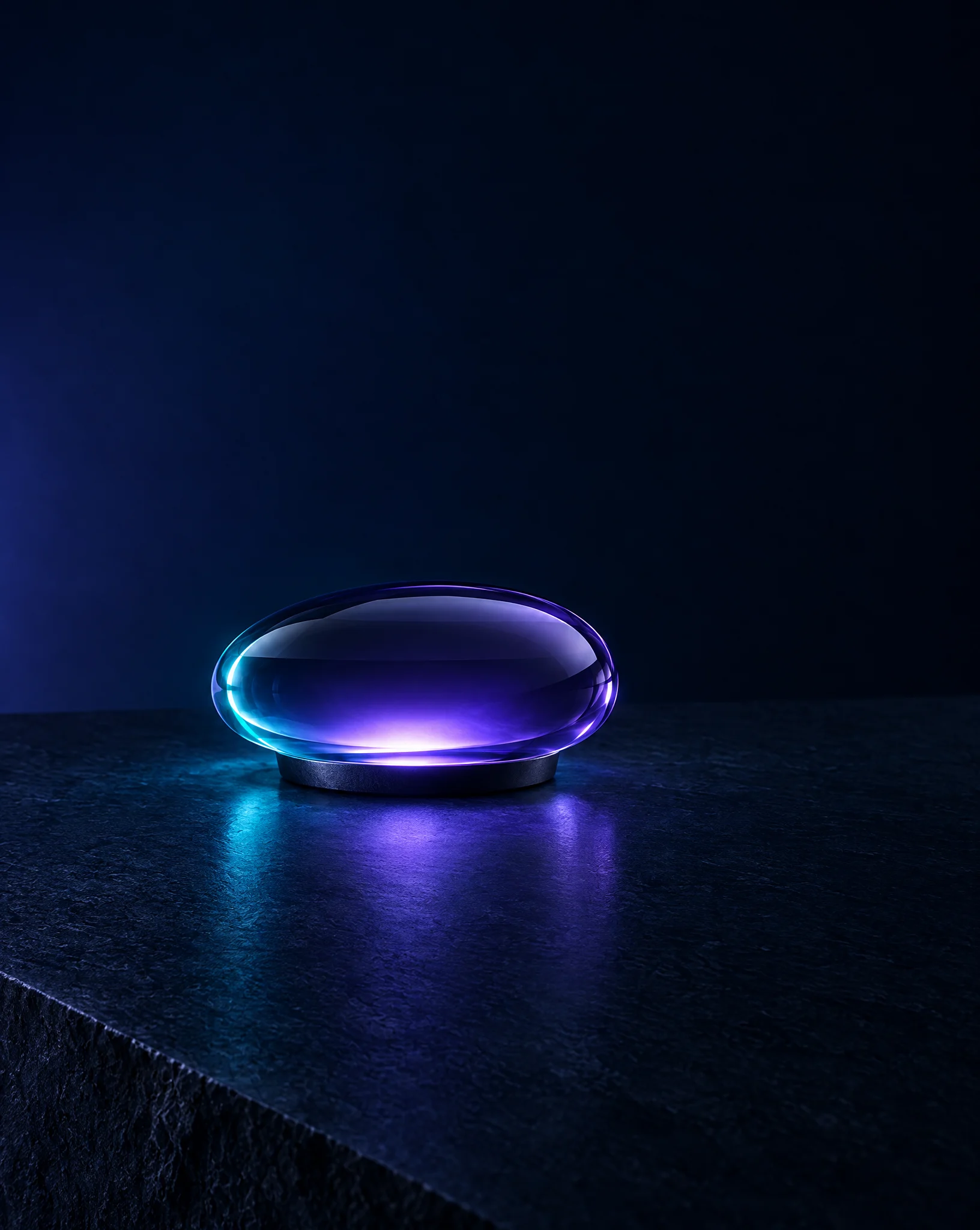 A low pebble-shaped glass table light glowing violet on dark stone