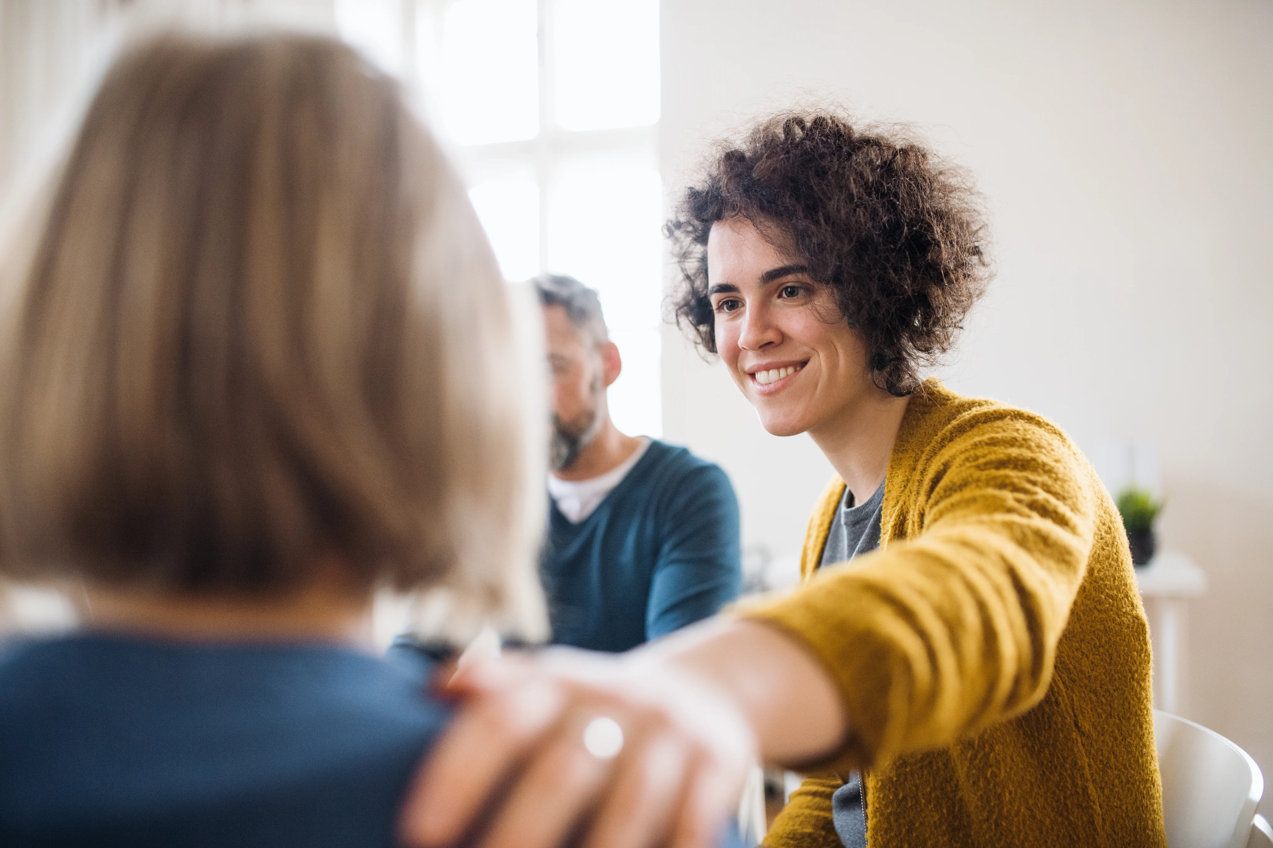 People taking part in a supportive group therapy meeting