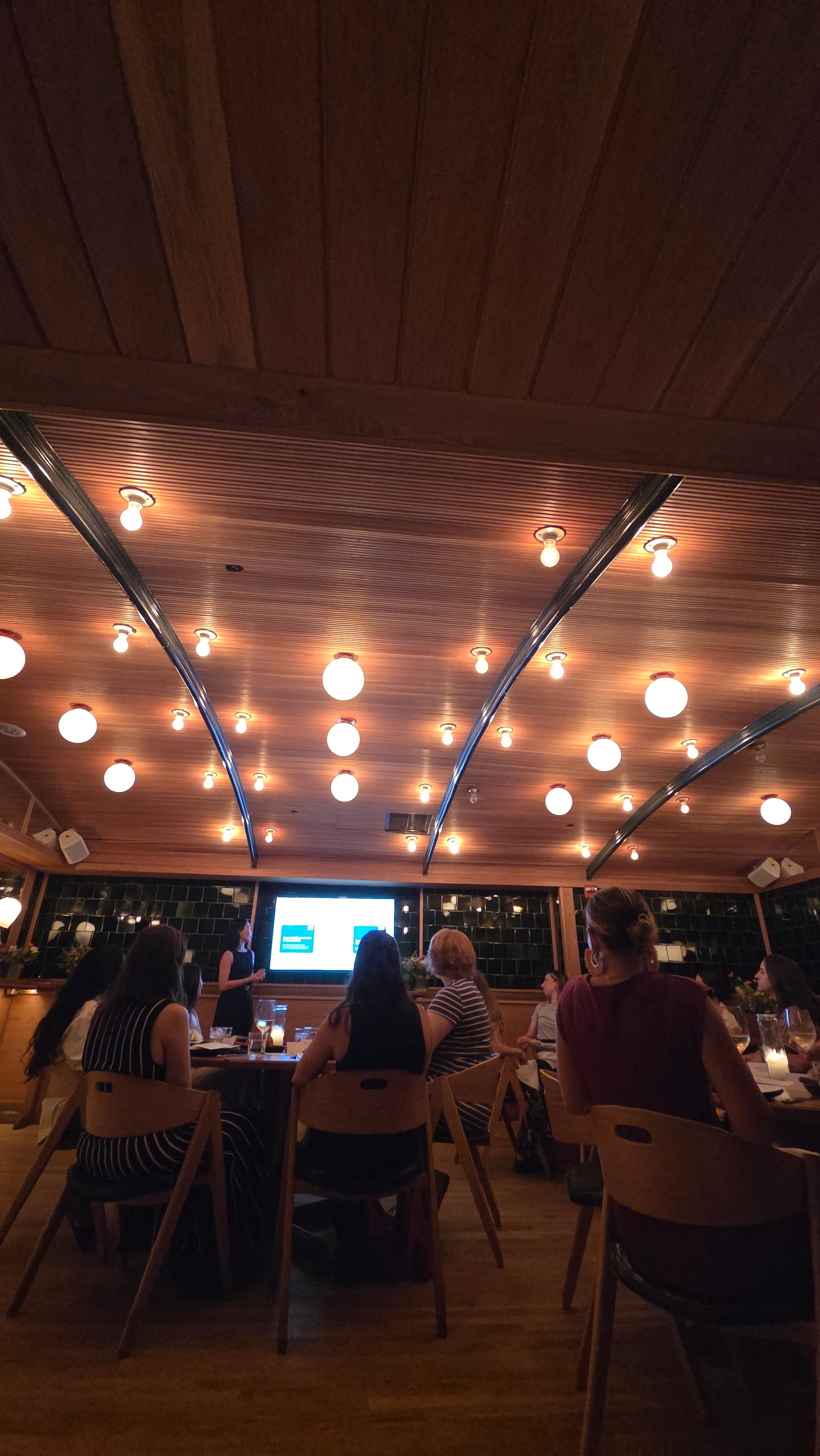 Event marketers listening to a presentation in Upland's private dining room