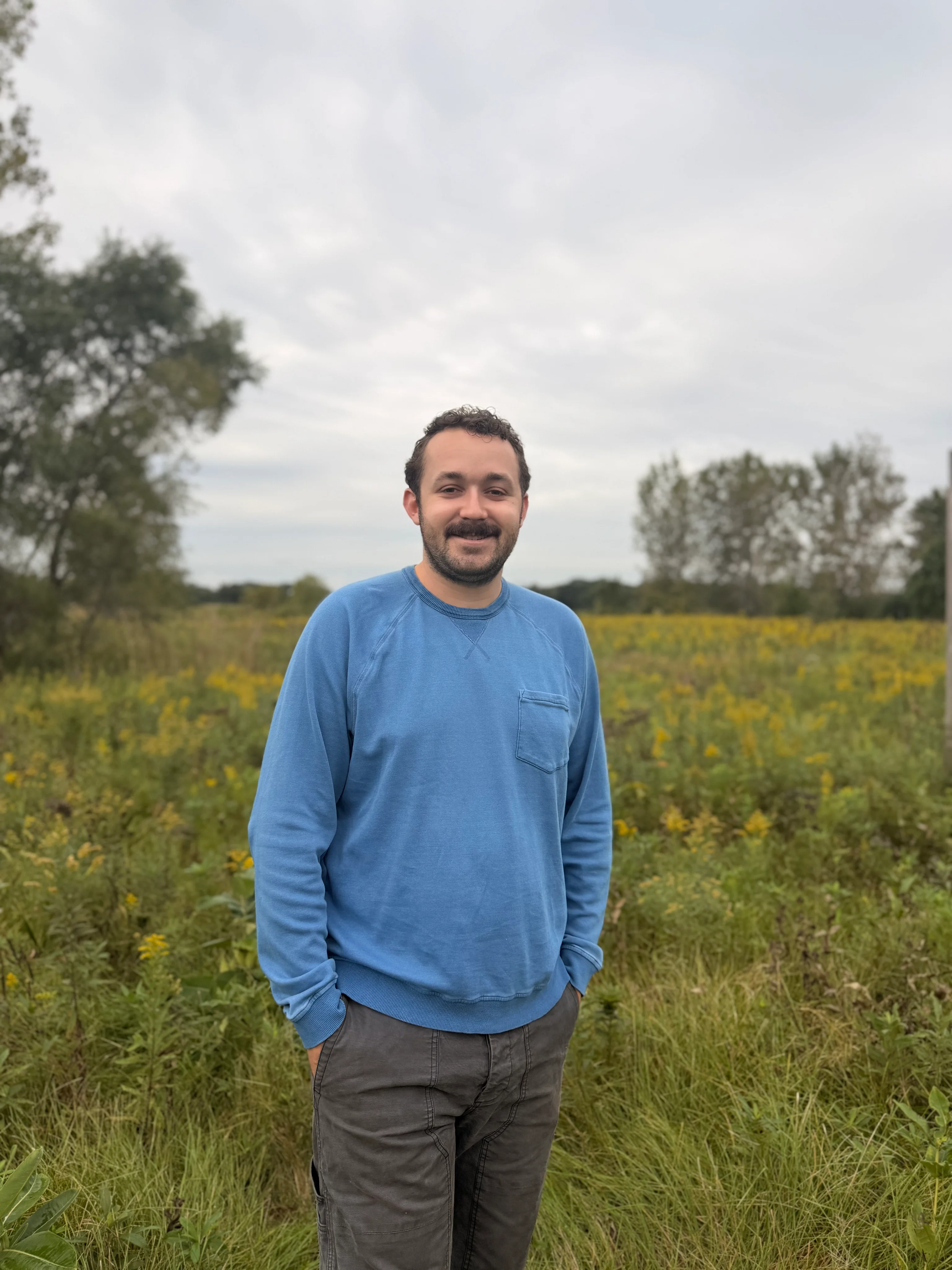 Robbie Levey standing in a meadow