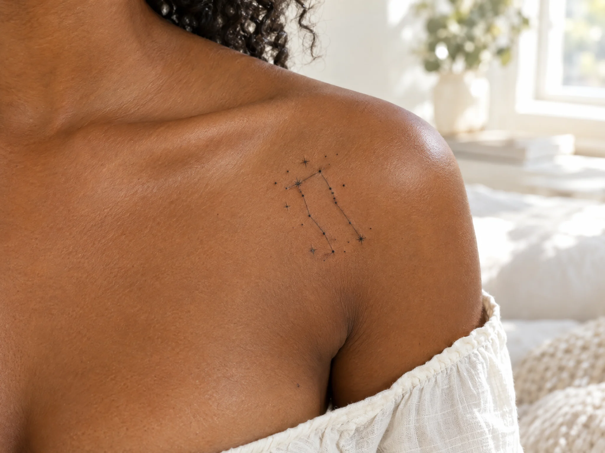 Gemini constellation temporary tattoo near the collarbone