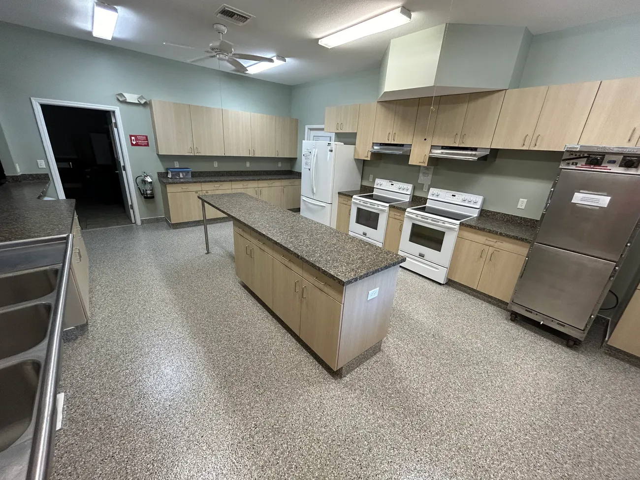Kitchen with a gray flake epoxy floor installed by Epoxy Floors N More