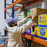 Small business owner organizing inventory inside a WareSpace unit