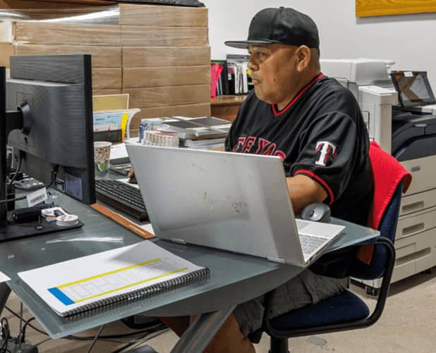 Tenant working at a desk inside a work-friendly WareSpace small warehouse unit