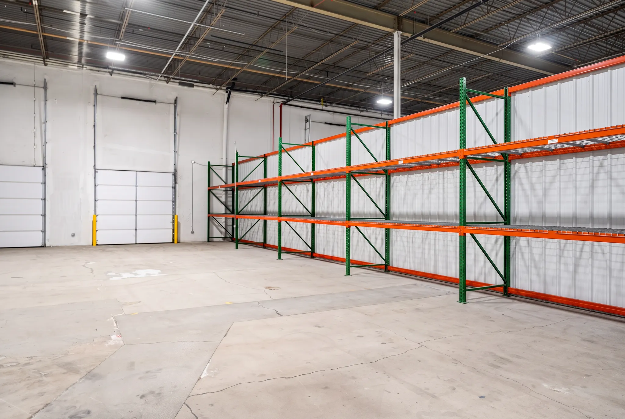 Inside a large private WareSpace unit in Salt Lake City with industrial racking and two overhead loading doors