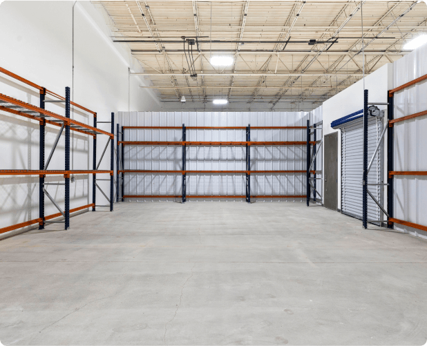 Empty WareSpace warehouse unit in Phoenix with industrial racking configured for vertical storage and a roll-up door