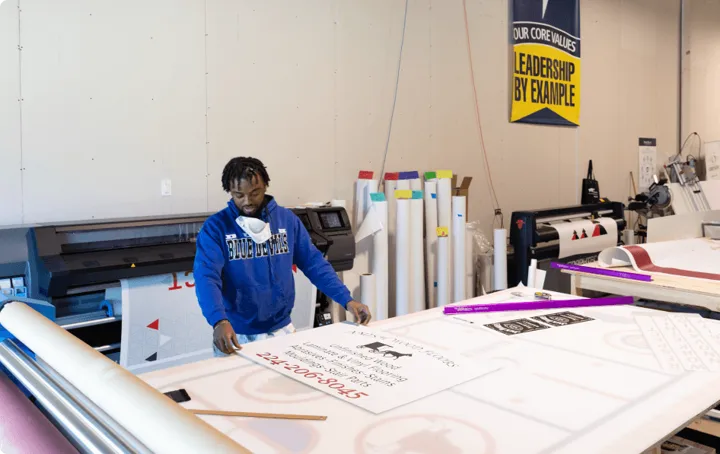 WareSpace tenant actively printing and assembling signage inside a production unit