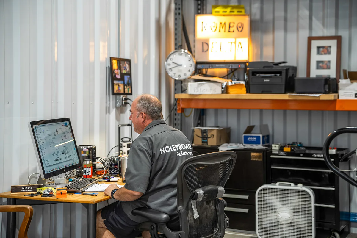 A WareSpace tenant working at a computer inside their warehouse unit