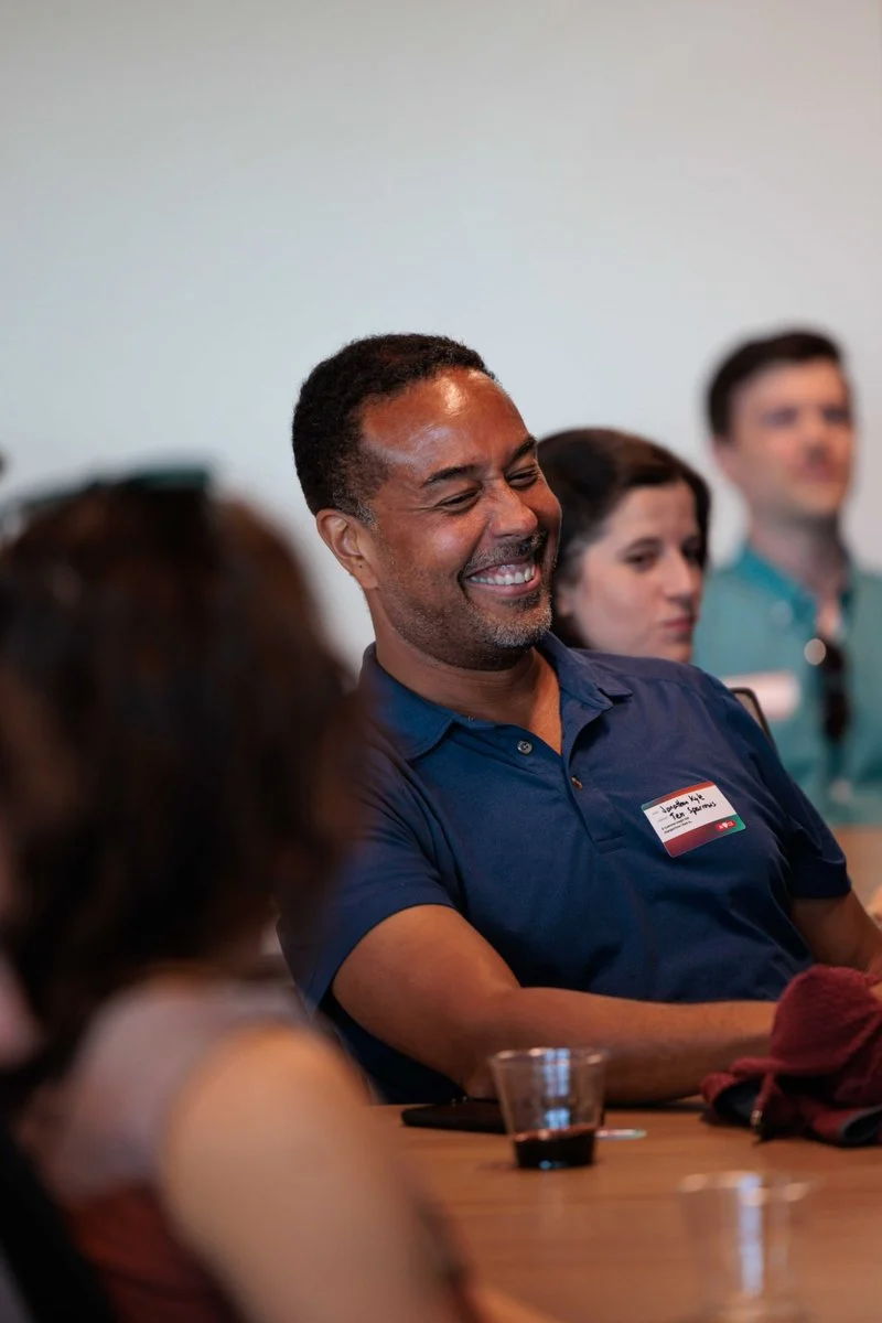An attendee laughs during the panel at AI ❤️ CX Atlanta