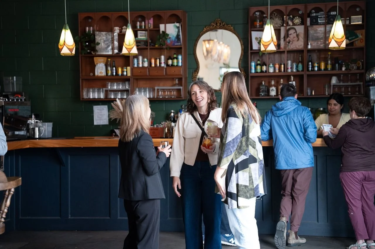 Guests chatting over drinks at the bar during an AI ❤️ CX evening