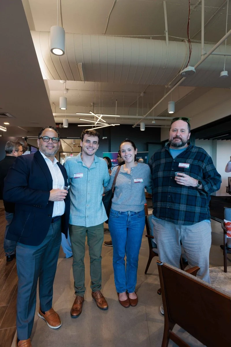Four attendees pose together during networking at AI ❤️ CX Atlanta