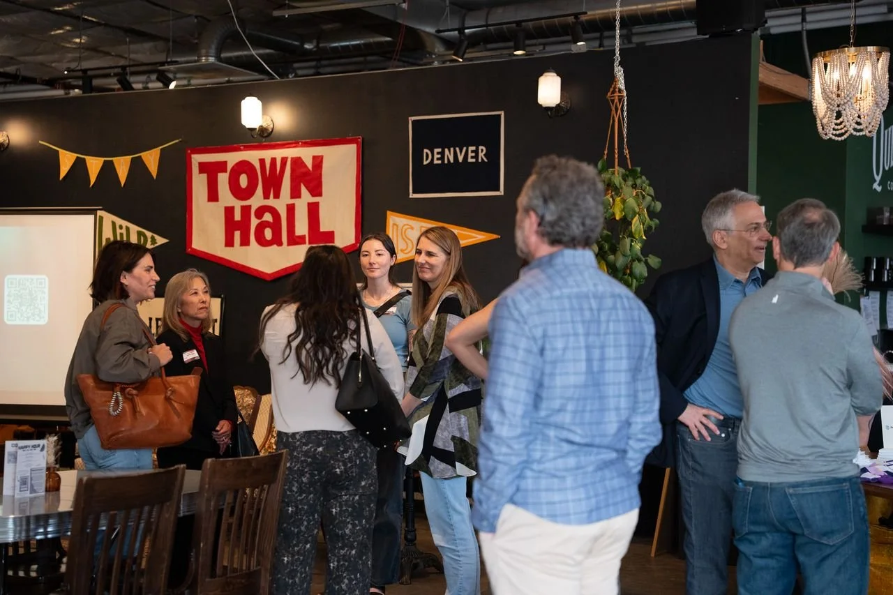 CX leaders talking in small groups at the AI ❤️ CX evening at Town Hall Collaborative in Denver