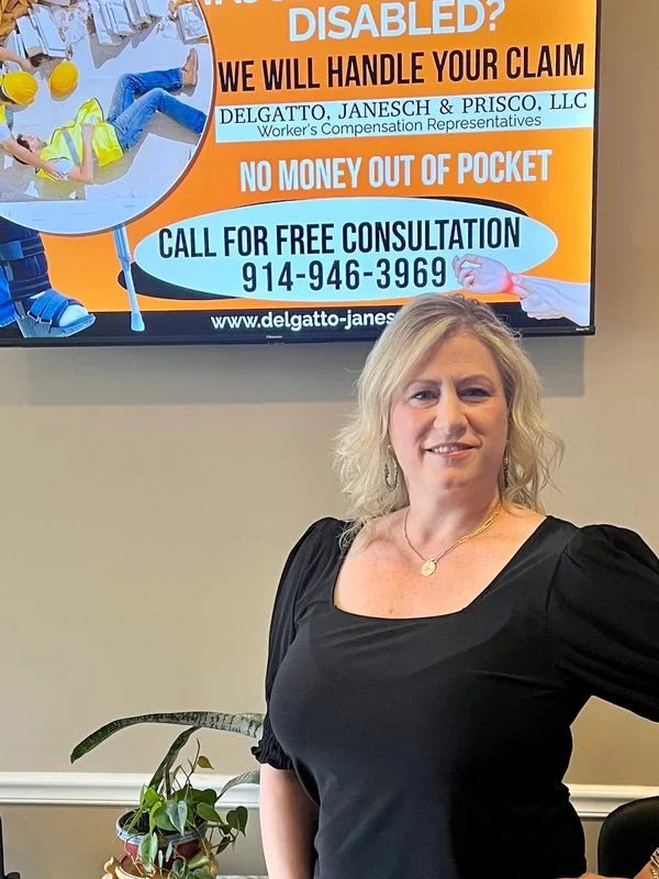 Marie, founder of DigitizeTV, standing beneath a digital display