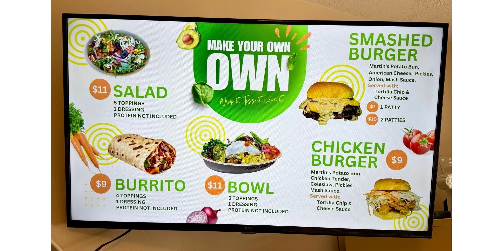 Digital restaurant menu board with salads, burritos, bowls, and burgers