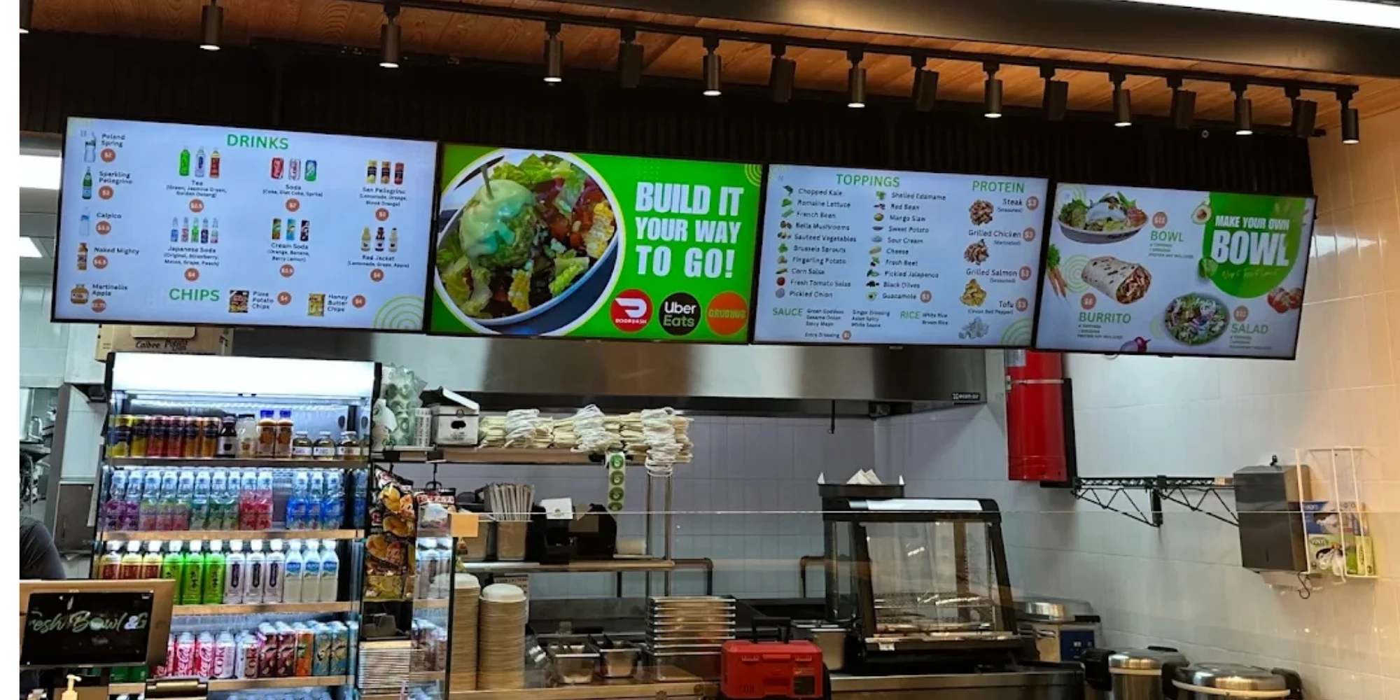 Restaurant digital menu boards above a service counter