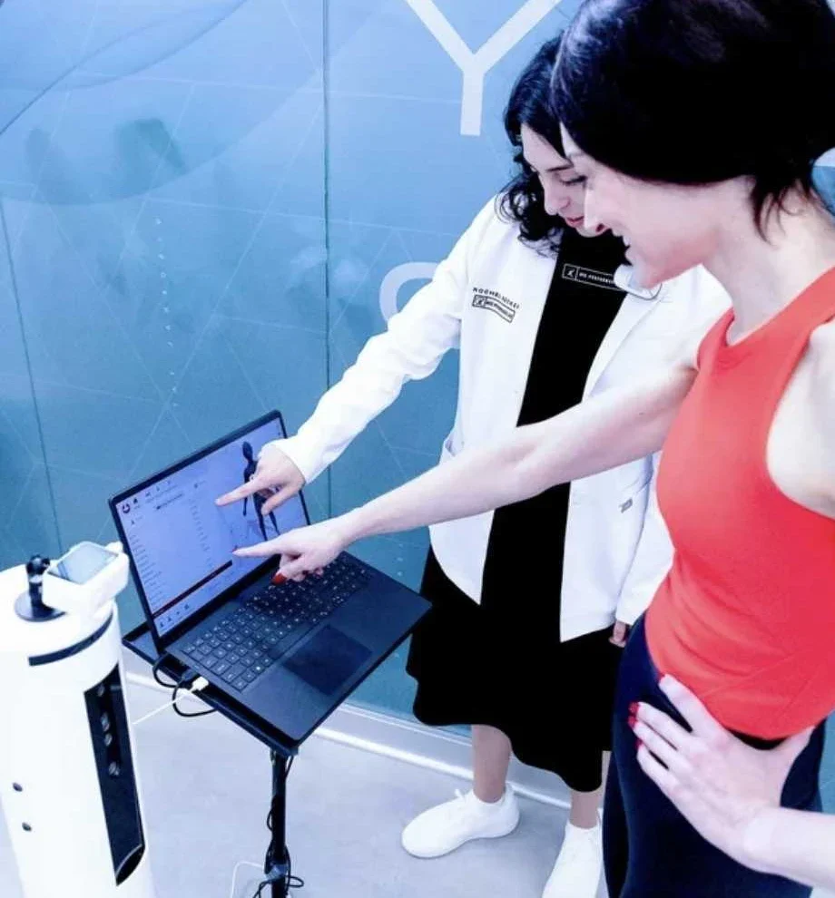 Client and specialist reviewing 3D body scan data at NYC Performance Lab