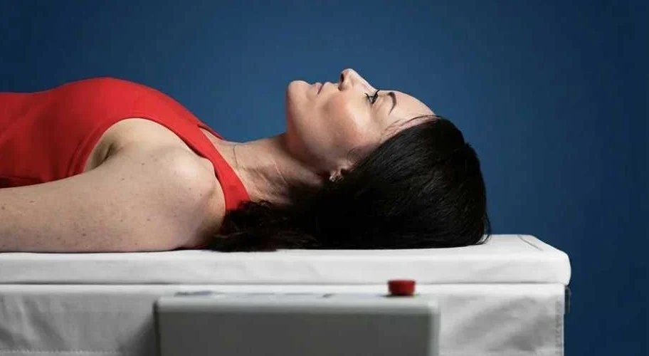 Client lying on the DEXA scan table during her assessment
