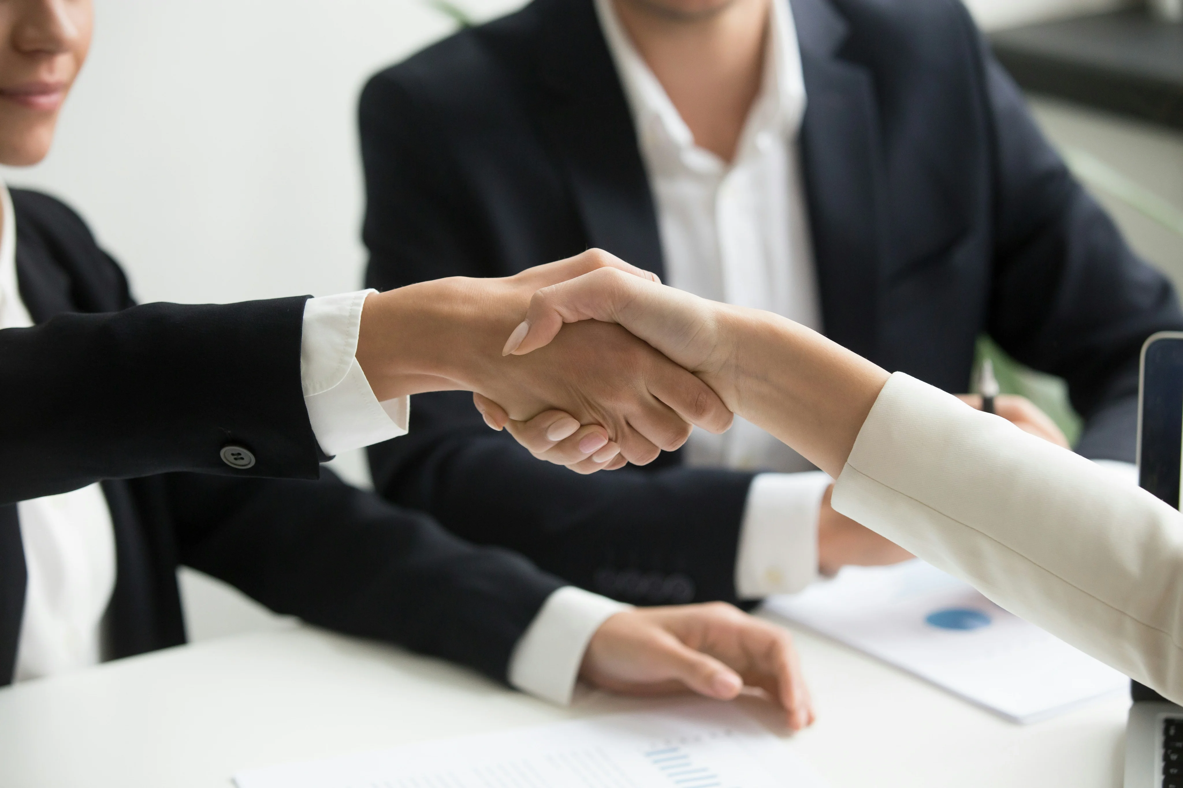 Business professionals shaking hands during a meeting