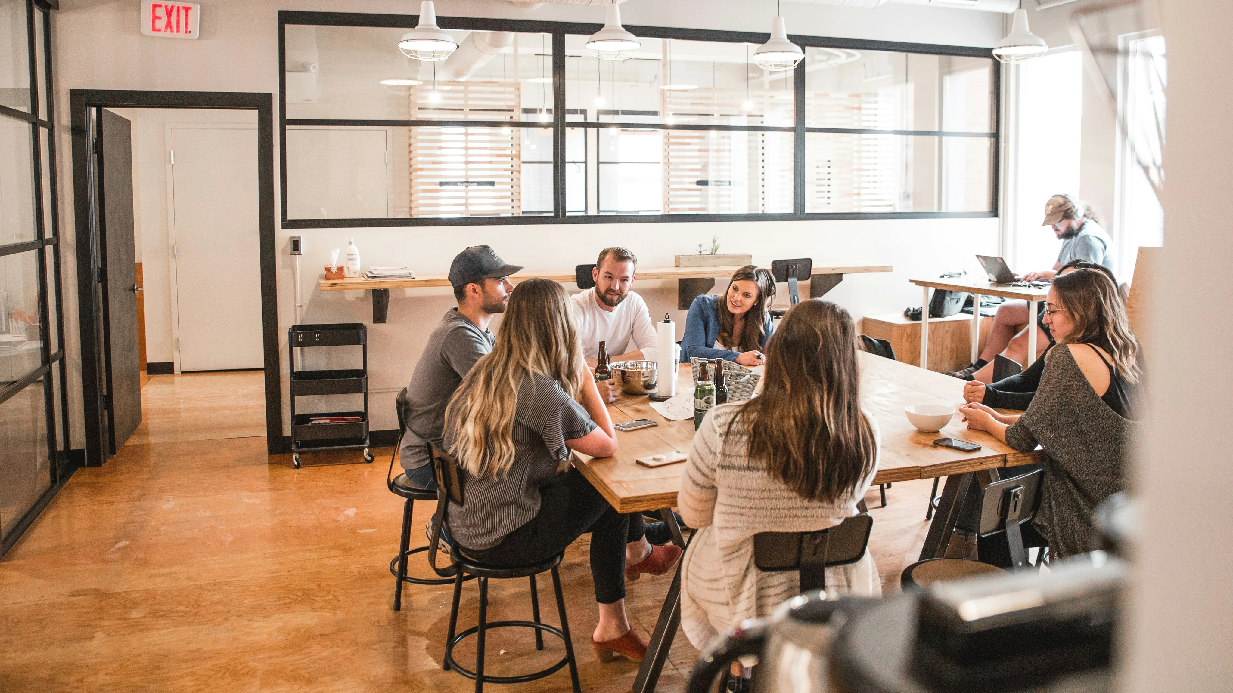 Team gathered around a table in a bright modern office