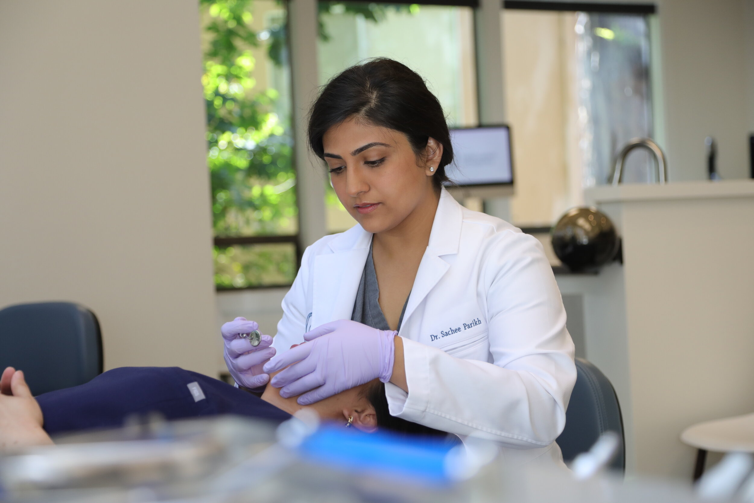 Dr. Sachee Parikh treating a patient chairside at her Mill Valley orthodontic office