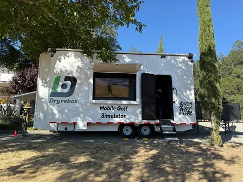 Dryvebox climate-controlled golf simulator trailer set up outdoors