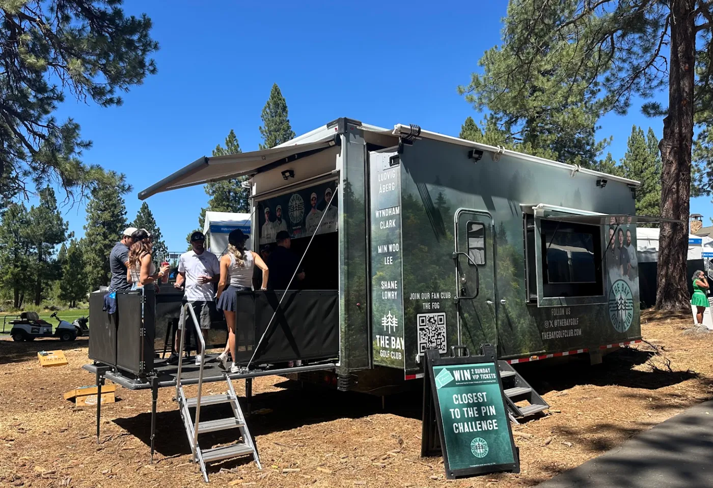 The Bay Golf Club Dryvebox trailer at the Barracuda Championship with guests on the party deck