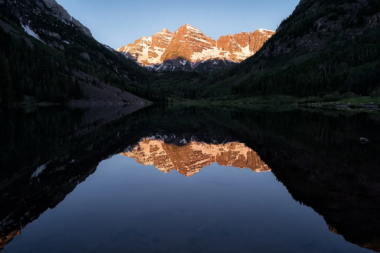 Maroon Bells reflected in Maroon Lake at sunrise near Aspen, Colorado