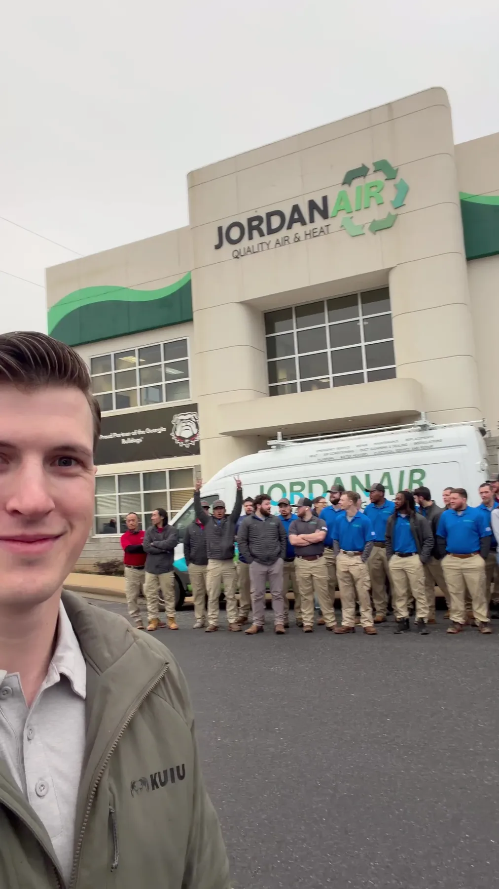 Chantz Yager with a client's team outside their business