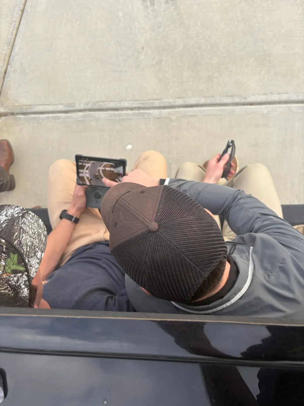 The crew reviewing drone footage between takes