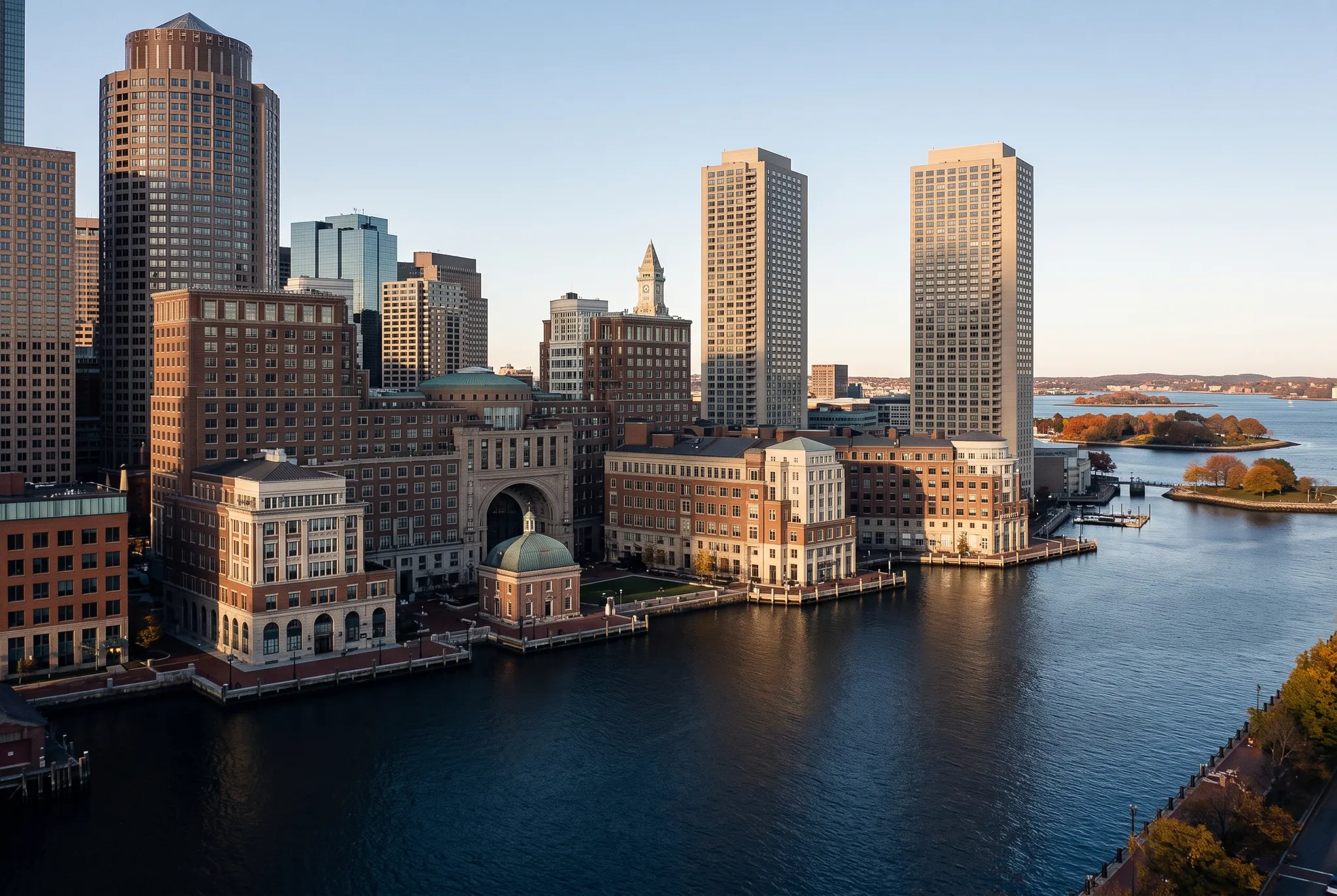Boston waterfront and downtown skyline in warm late-afternoon light