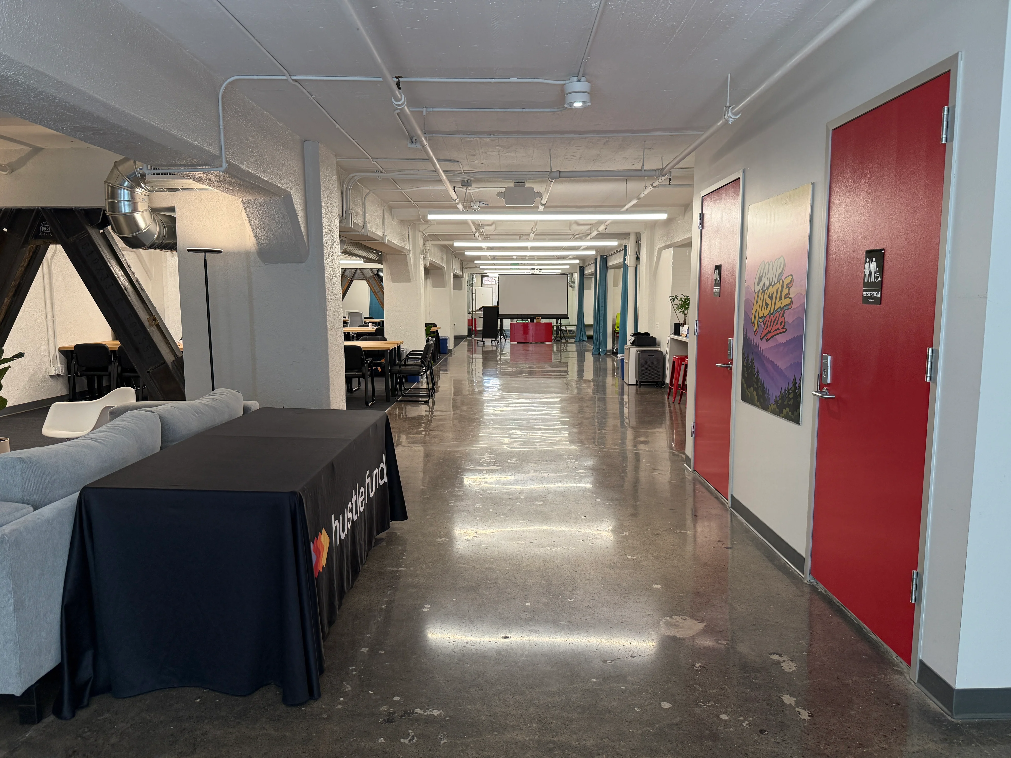 The bright industrial hallway connecting the Hippo Campus rooms.