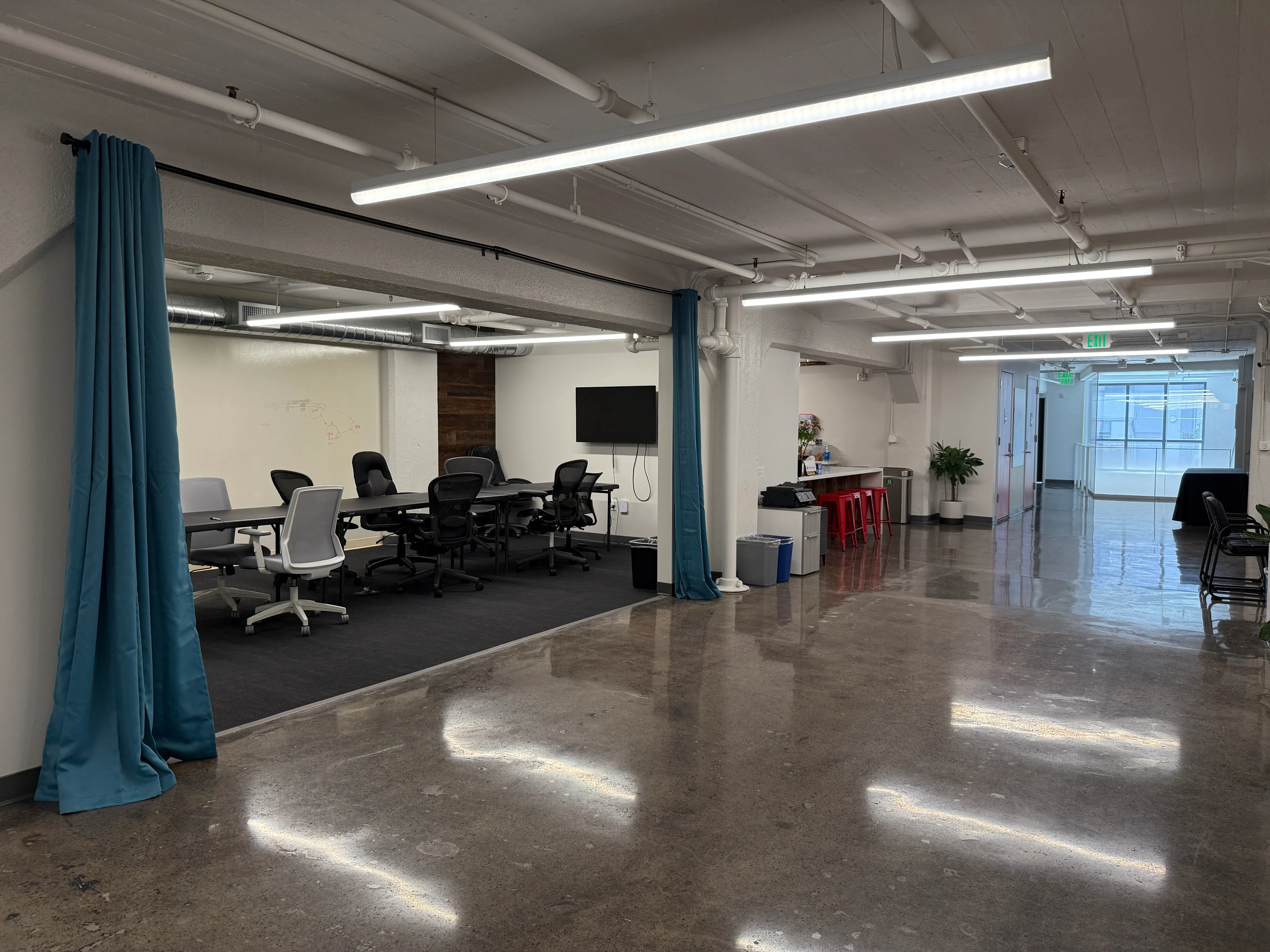 Flexible open space with curtained rooms for focused conversations.