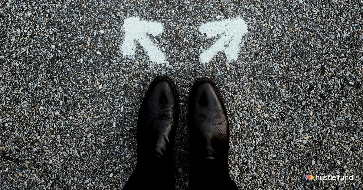 Black shoes facing two white arrows pointing in opposite directions