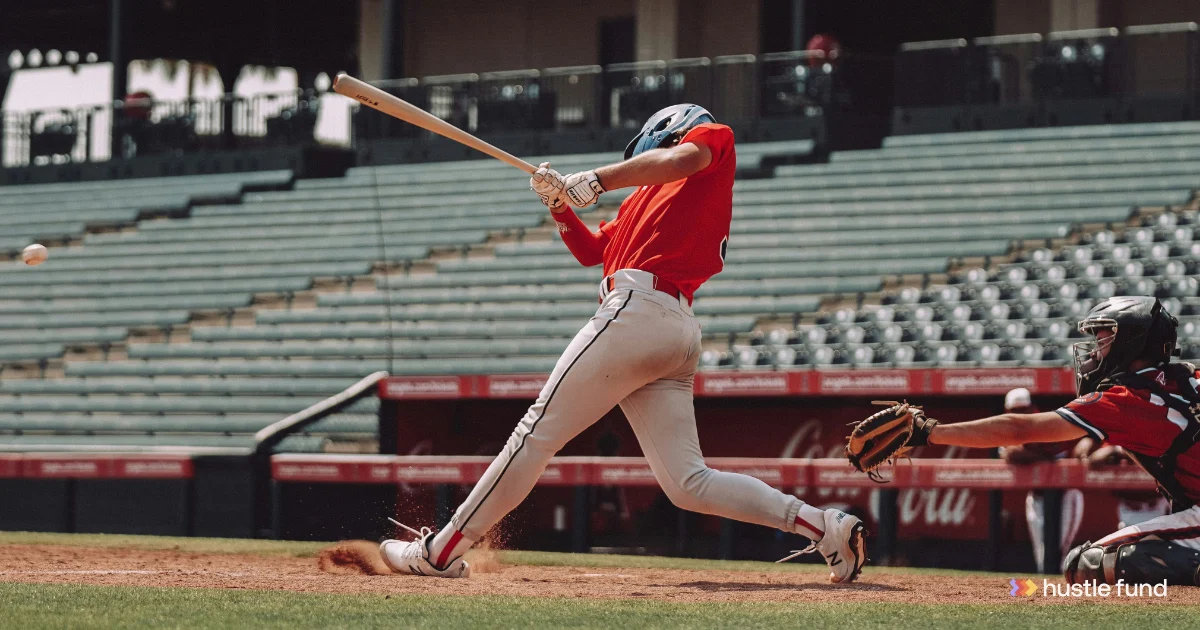 Baseball hitter swinging at a pitch, with a catcher behind him and a Hustle Fund logo at the lower right