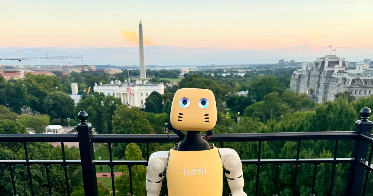 Lightberry's Lumi robot on a balcony overlooking Washington, with the Washington Monument behind it