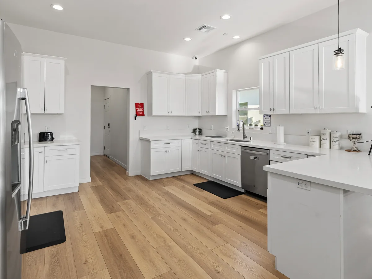 Residential kitchen with white cabinets and stainless steel appliances