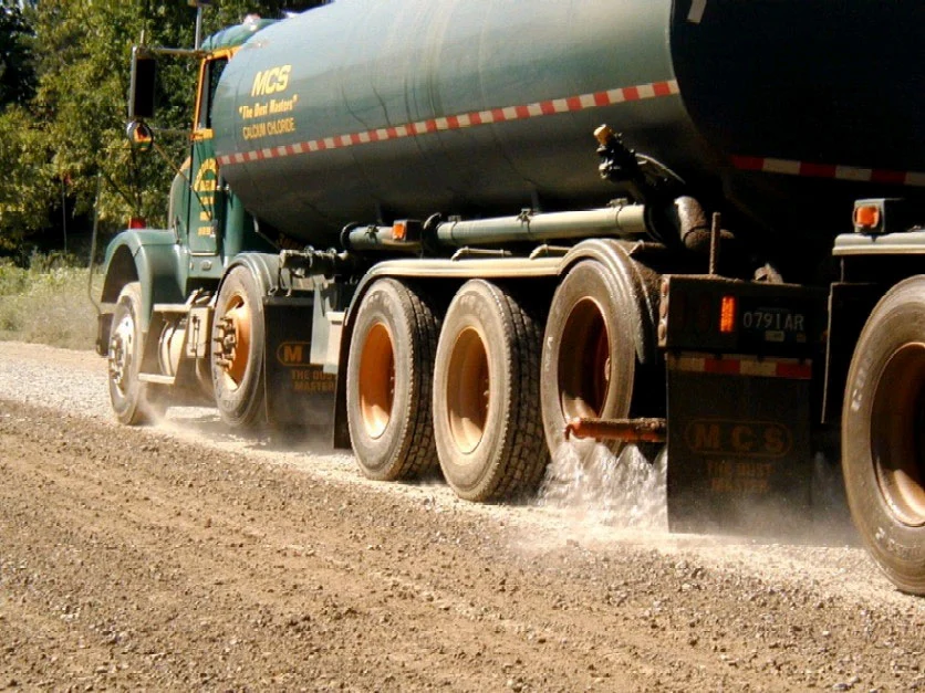Dust control treatment applied by an industrial tanker truck
