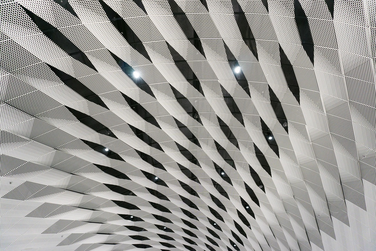 Radiating perforated-metal architectural facade, precision and structure