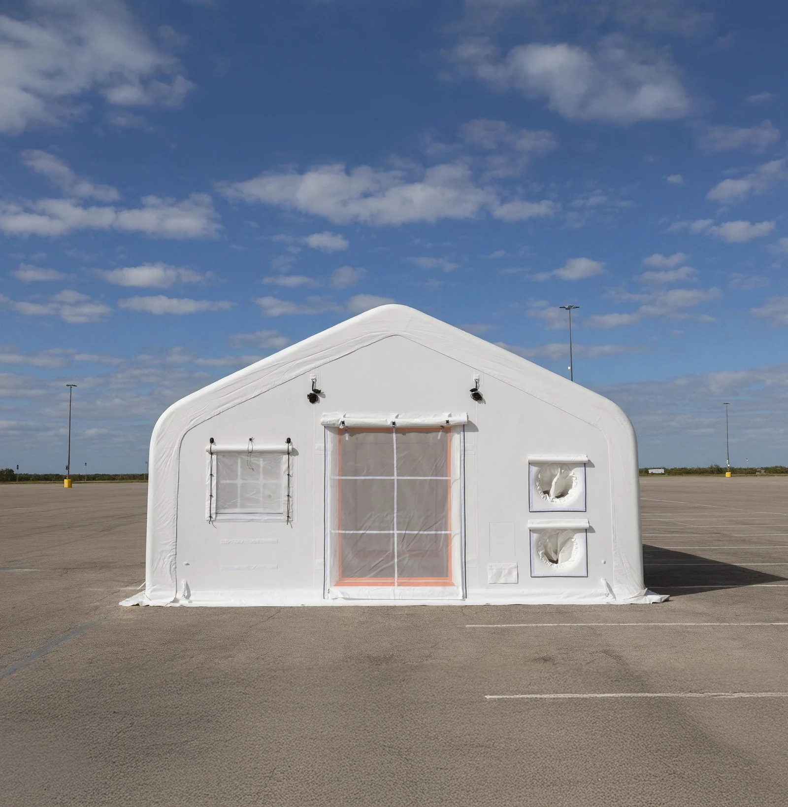 Full front view of a white drop-stitch inflatable tent showing the entrance, window and two circular openings