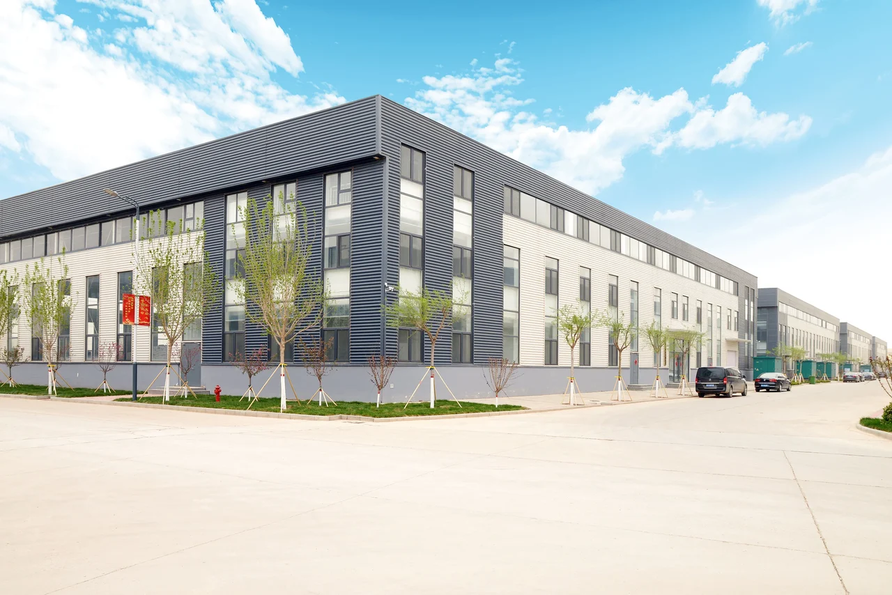TPYS factory exterior with workshop buildings and the access road