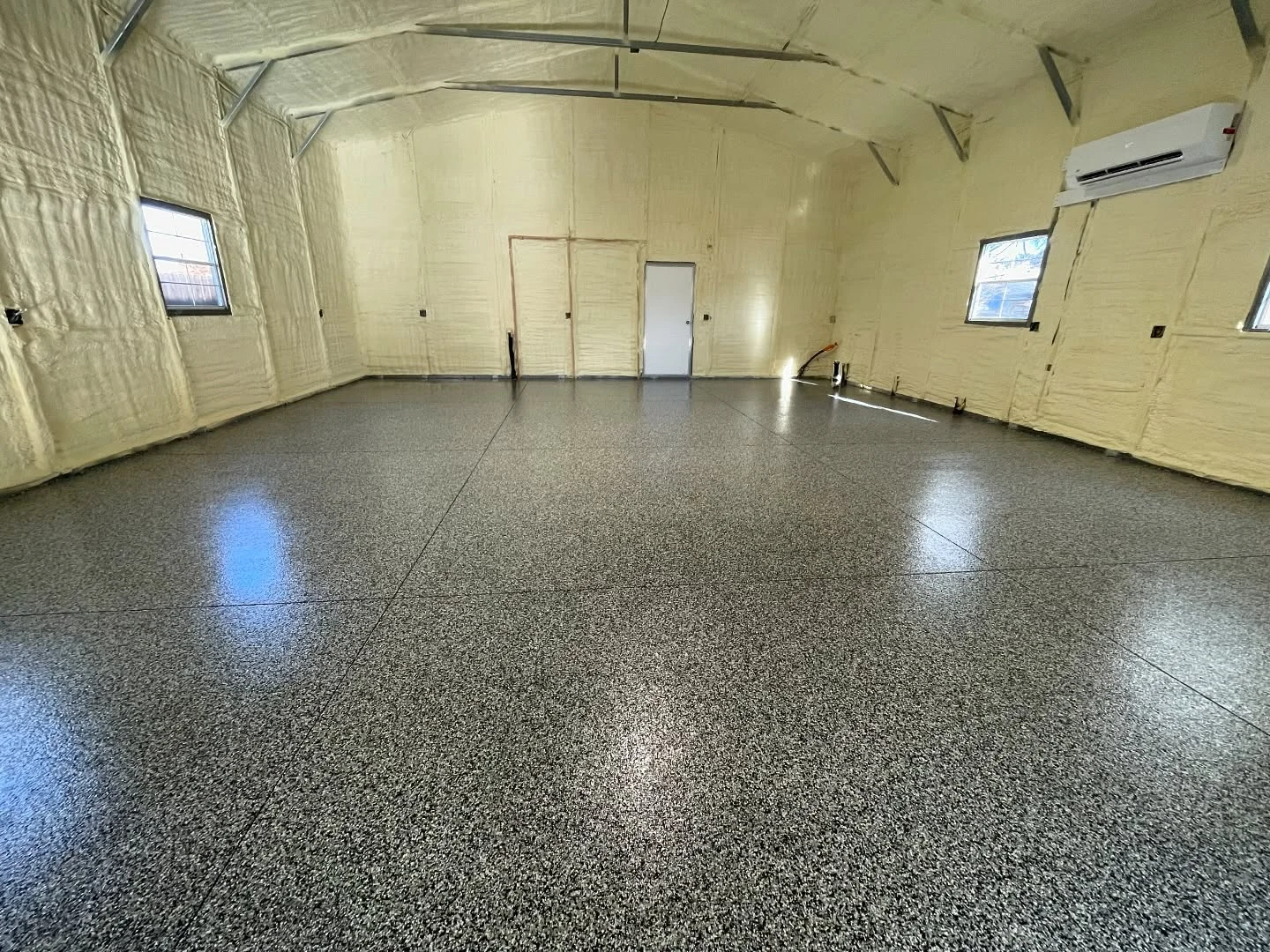 Dark gray flake floor inside an insulated workshop