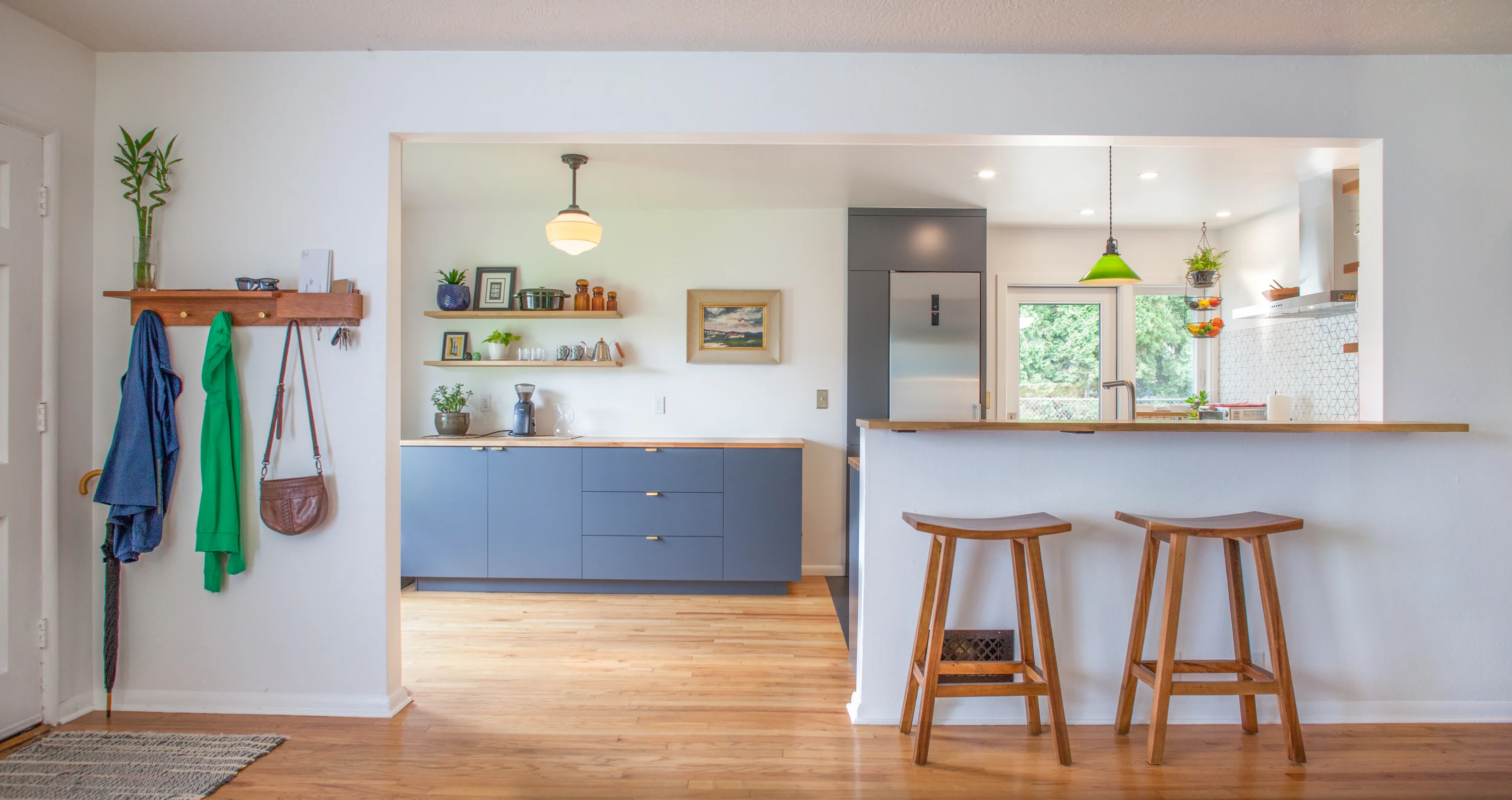 Contemporary Kitchen remodel with blue lower cabinets and bar stools