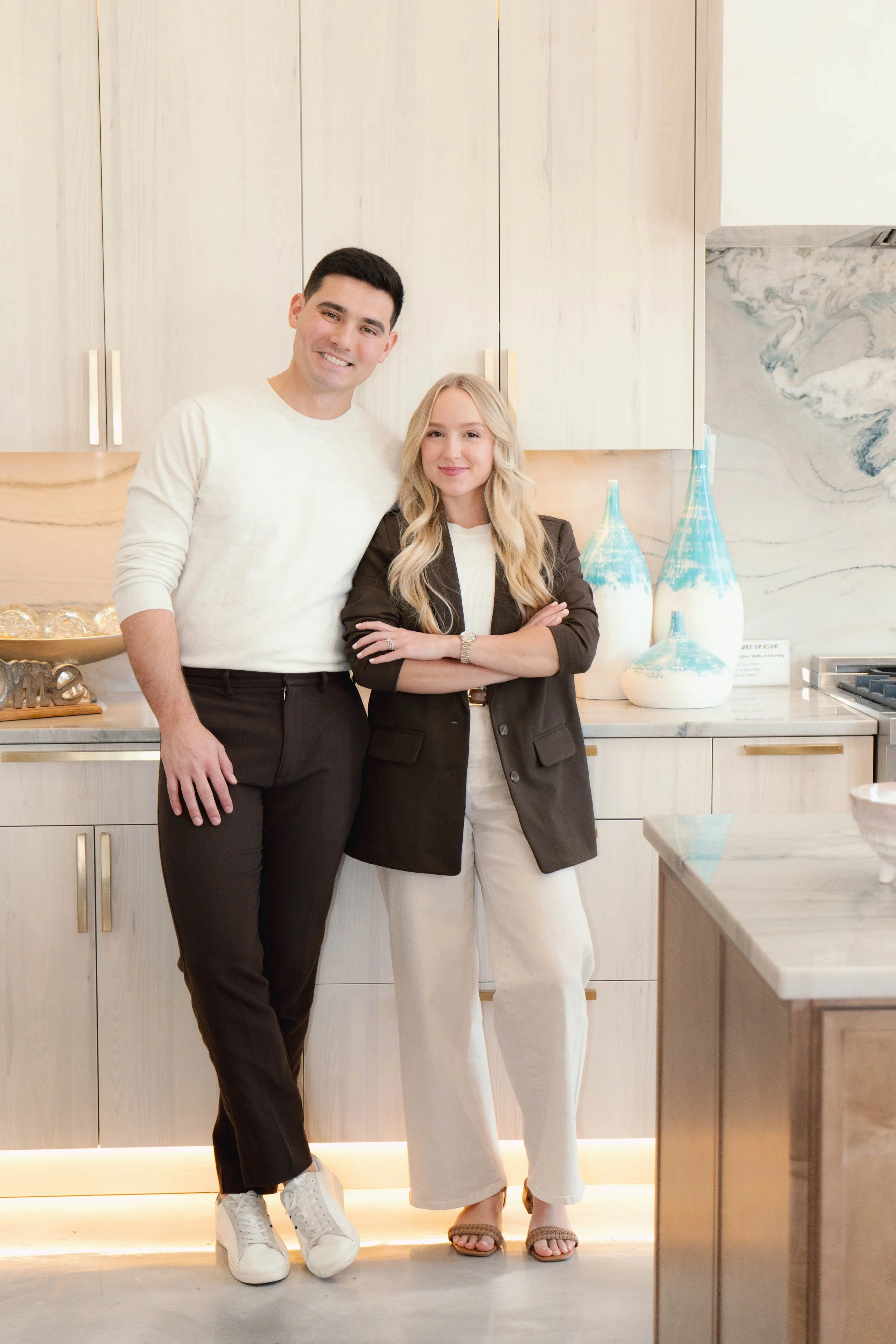 Derrick and Emily Sumner standing together in a bright kitchen