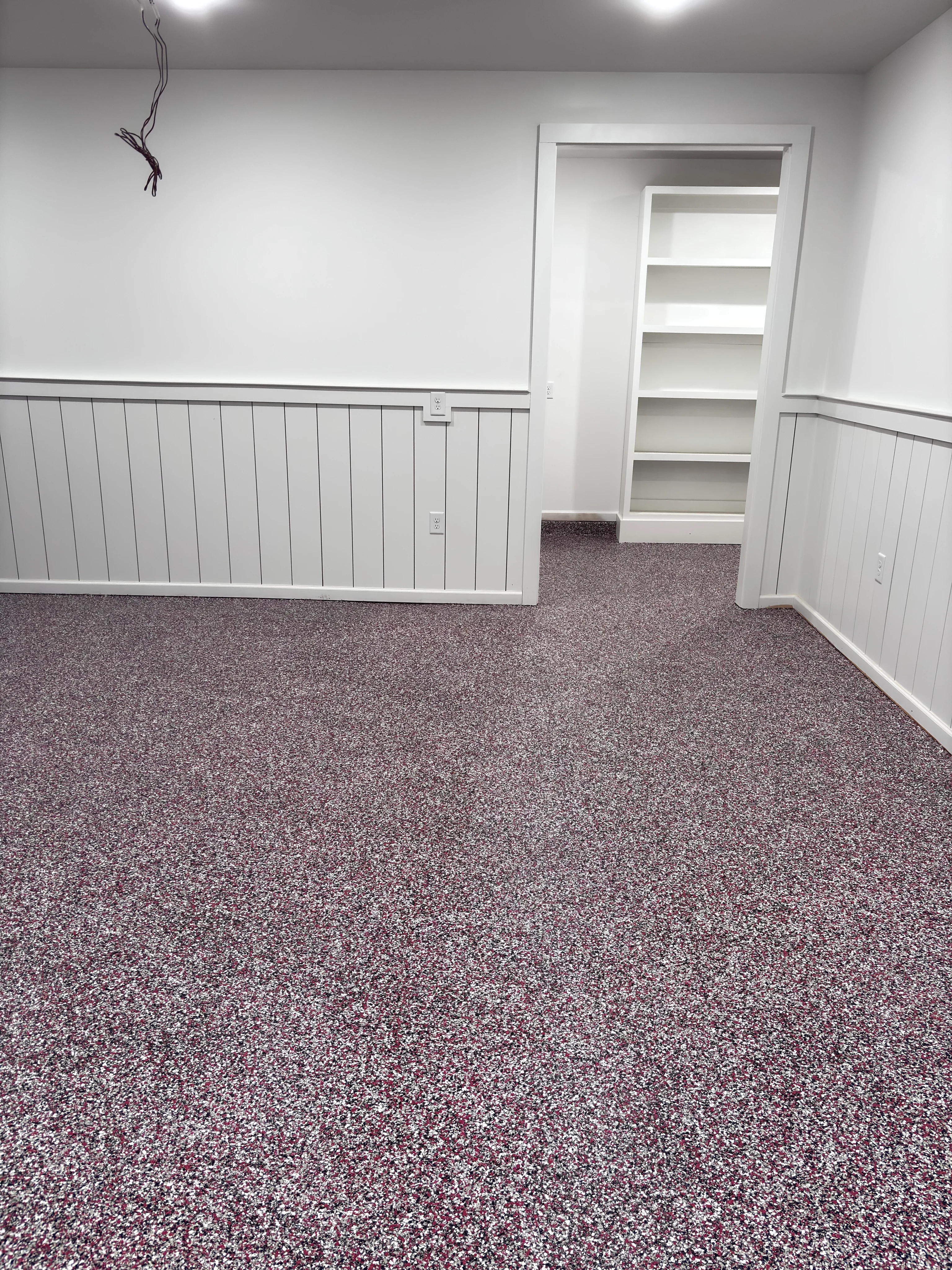Purple and gray speckled epoxy floor in a white room