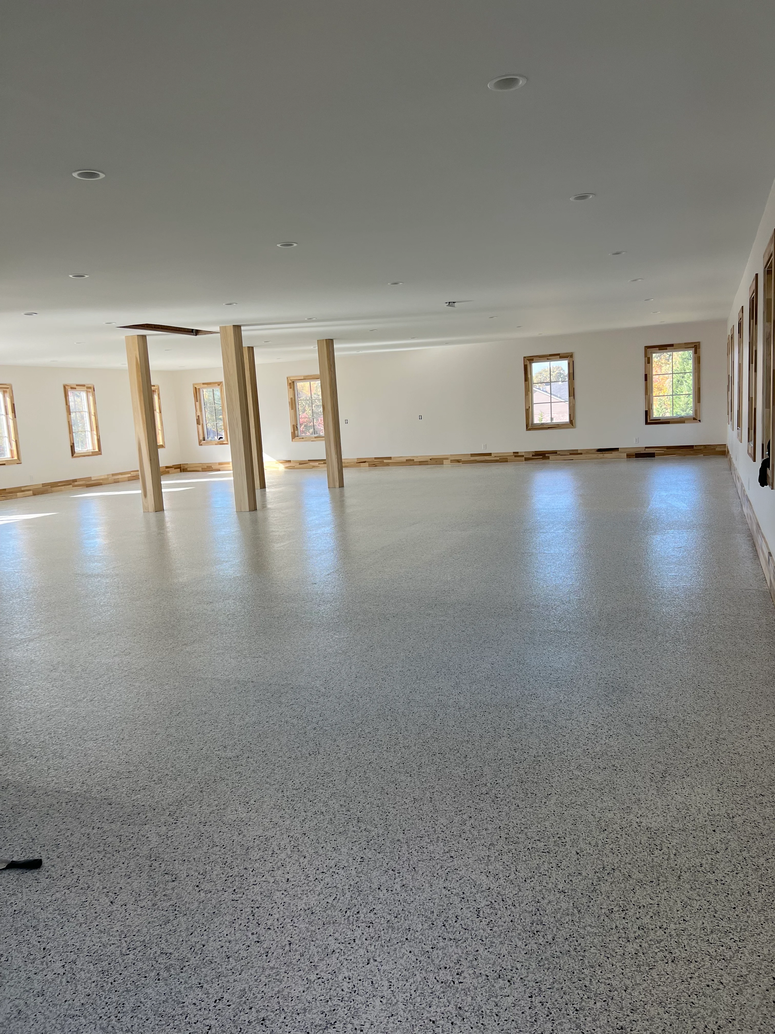 Reflective speckled floor in a large empty room