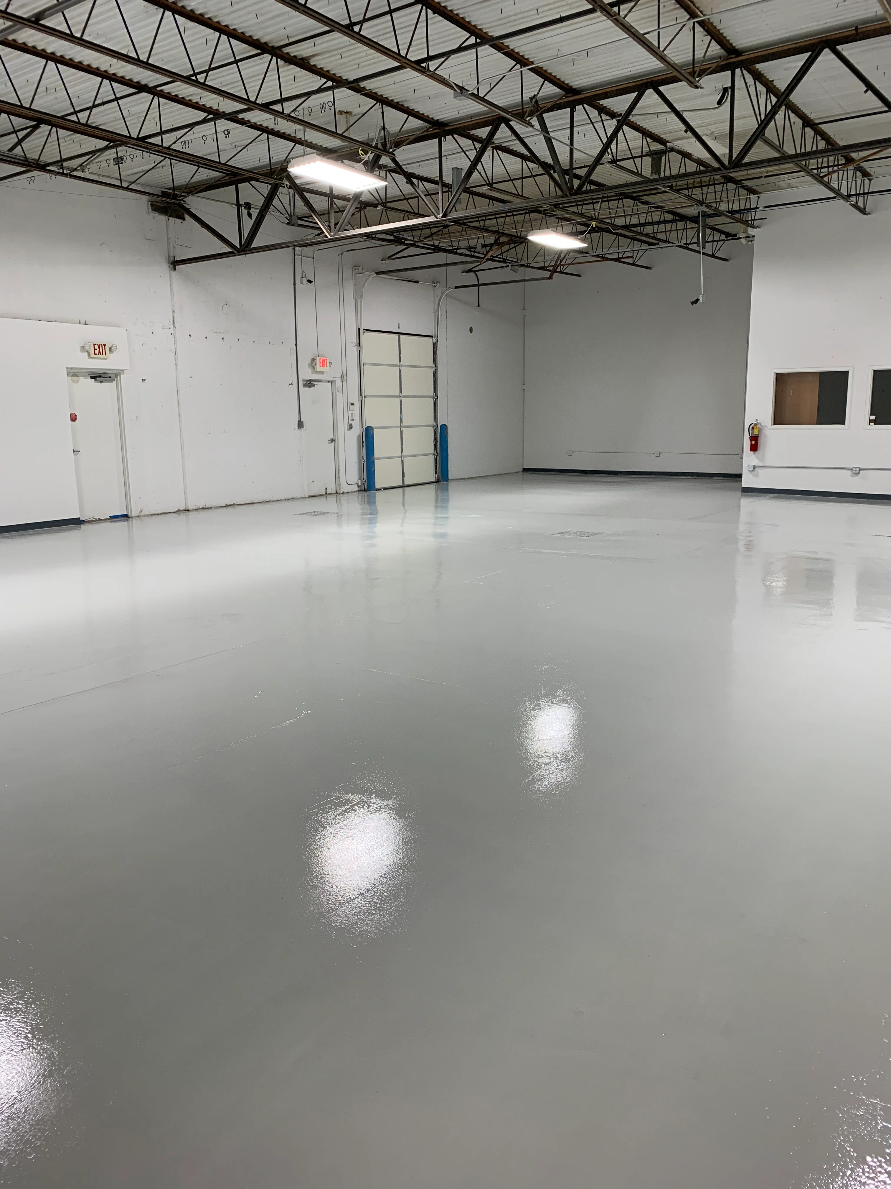 Reflective gray coated floor in an industrial warehouse