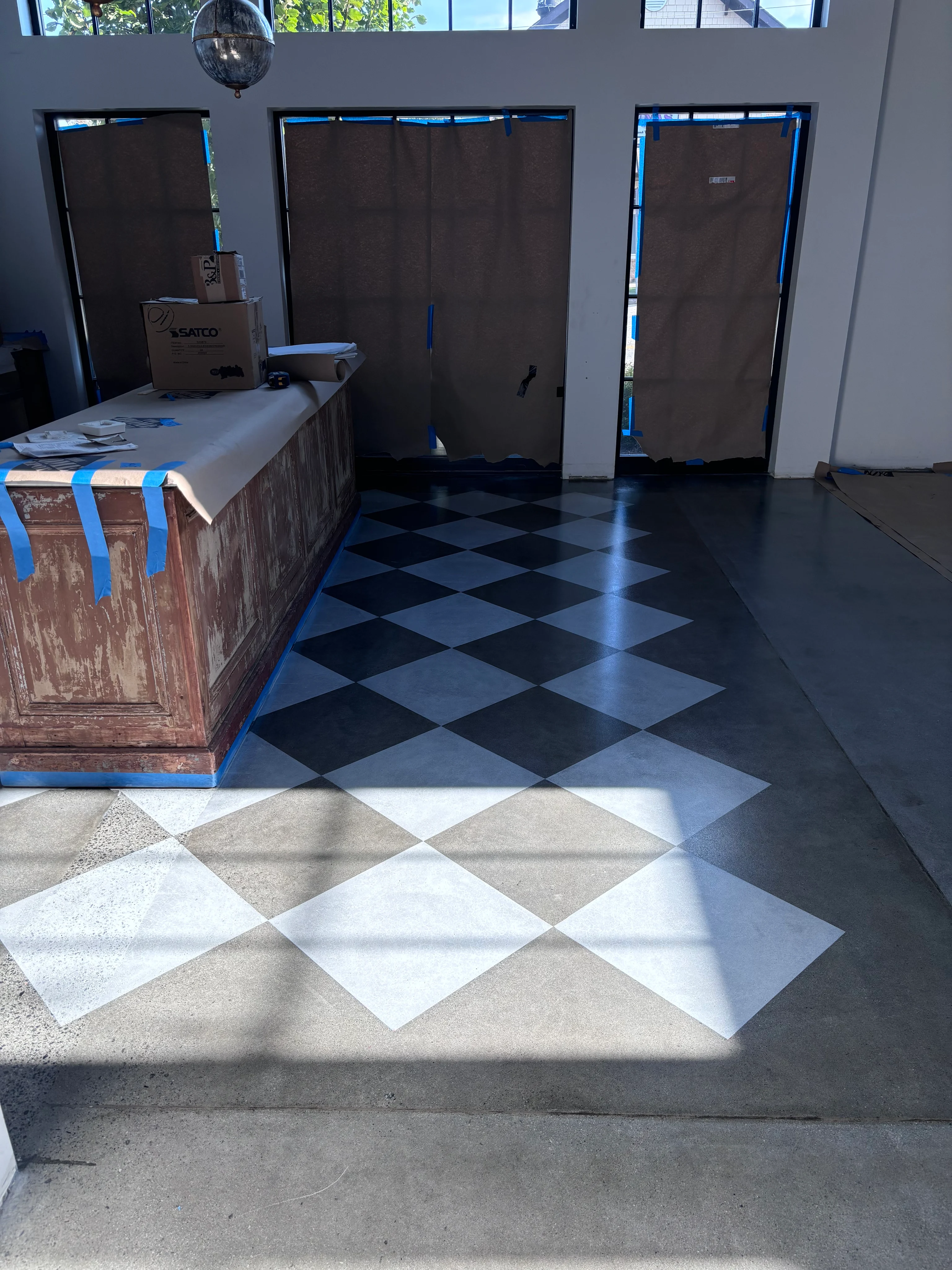 Diamond-patterned concrete floor beside a wooden counter