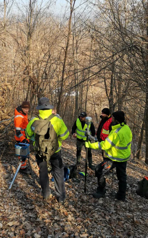 Geologists in high-visibility vests in the field in Serbia